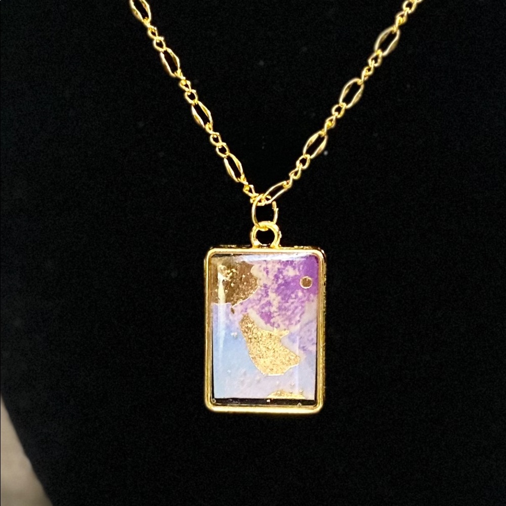 Purple, blue and metalic gold resin 1” pendant on gold 22”necklace
